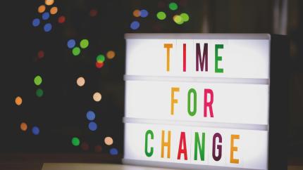 A text board with the words "Time For Change"