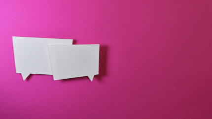 Two speech bubbles sit on a pink background