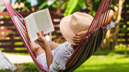 Woman in hammock reading a book