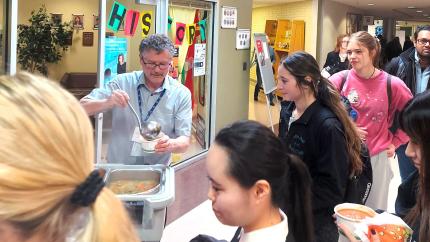 George Koopman dishes out food while students line up