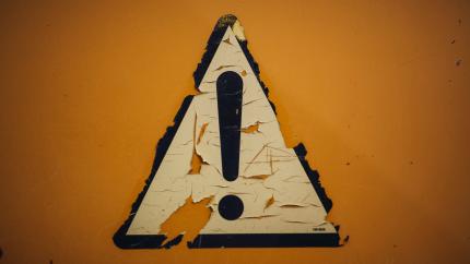 Image of a sign indicating attention. Courtesy of Unsplash.