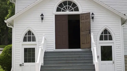 A church stands with open doors. Courtesy of Unsplash.