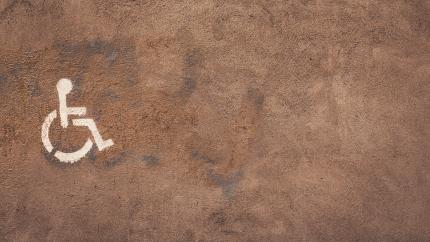 Image of the disability sign against a brown backdrop. Courtesy of Pixaby.