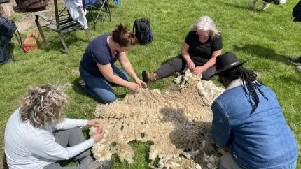 A group of people work on a crafting project during an on-the-land learning event. Courtesy of Kristen Parker.