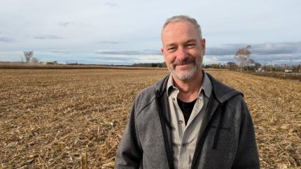 Peter Timmerman stands again a background of a field. Courtesy of World Renew.