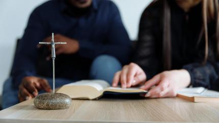 Two people read a bible together. Courtesy of Thirdman on Pixaby.