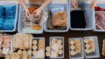 A group of people volunteer by putting together donation boxes. Courtesy of Pexels.