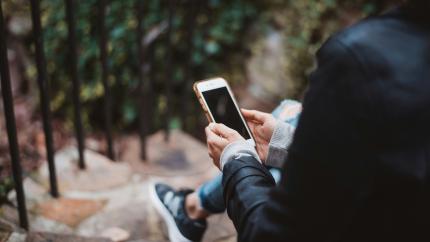A person looking at a smart phone