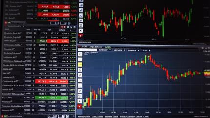 Computer screen is shown with a full range of stock analysis lines in red and green.