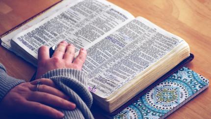 Photo courtesy of Pexels: https://www.pexels.com/photo/person-reading-bible-on-brown-table-38048/