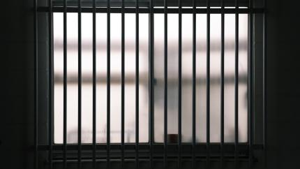 Image of a set of jail bars. Courtesy of Pexels.