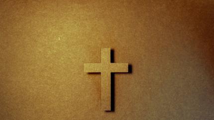 Cross centered on a brown background.