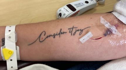 “Consider It Joy” arm tattoo near chemotherapy port