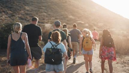A group of people walk together. Courtesy of Unsplash.