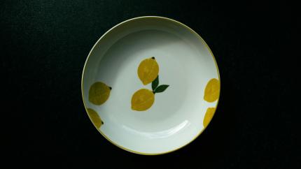 An image of a bowl placed on a dark table. Courtesy of Martin on Unsplash.