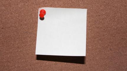 Meeting notepad is tacked into a wall