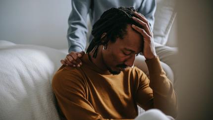 https://www.pexels.com/photo/sorrowful-black-man-touching-head-in-dismay-near-supporting-wife-5700186/