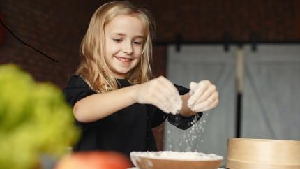 https://www.pexels.com/photo/happy-girl-putting-flour-on-hands-in-kitchen-at-home-3984747/