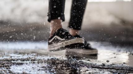 https://www.pexels.com/photo/crop-person-walking-through-puddles-on-asphalt-3908085/