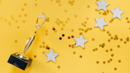 trophy and stars on yellow background