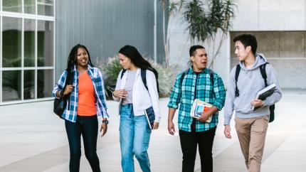 four college students walking and talking