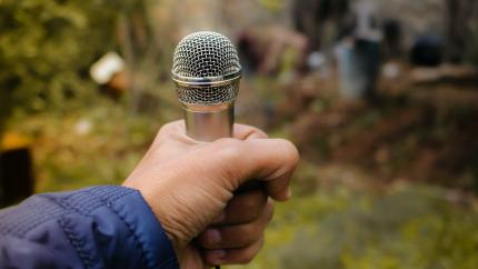 https://www.pexels.com/photo/close-up-photography-of-person-holding-microphone-1212843/