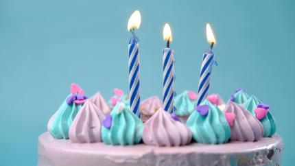 Image of a birthday cake with candles. Courtesy of Pexels.