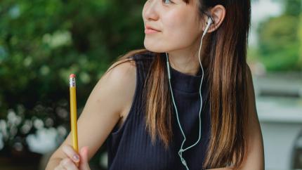https://www.pexels.com/photo/happy-young-asian-student-listening-to-music-while-studying-at-table-in-park-5538623/