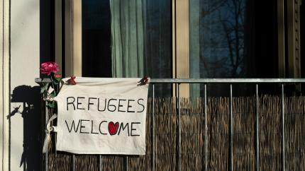 Banner with refugee welcome sign