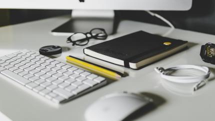 A computer desk with a mouse and keyboard