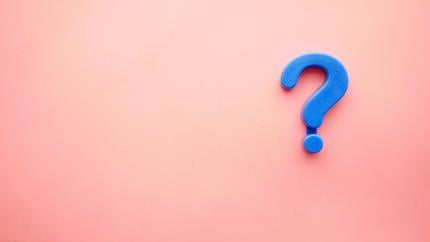 A blue question mark on a pink background