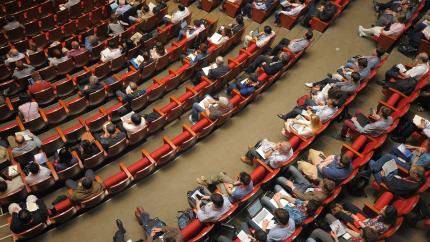 A large group of people sit together in a santuary.