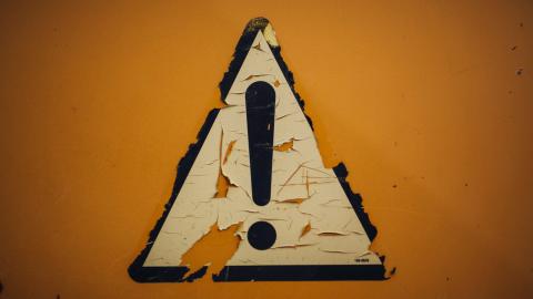 Image of a sign indicating attention. Courtesy of Unsplash.
