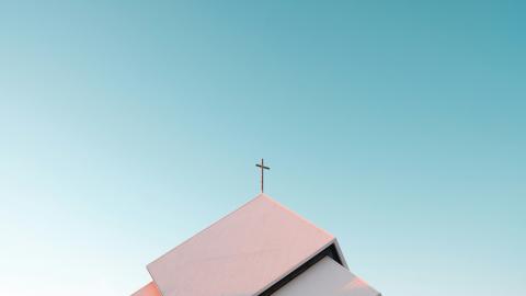 An image of a church steeple against the background of a blue sky. Courtesy of Pexels.