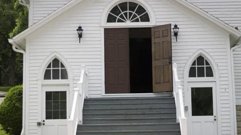 A church stands with open doors. Courtesy of Unsplash.