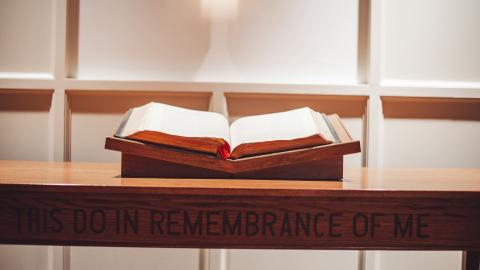 Image of an empty pulpit with a Bible on it. Courtesy of Unsplash.