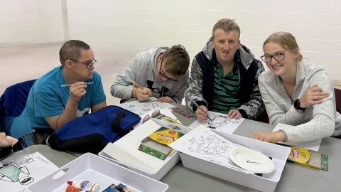 A group of people at Friendship Ministry working on a craft