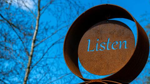 An outdoor sculpture with the word 'Listen'