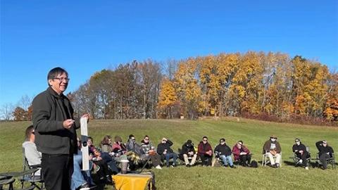 Adrian Jacobs speaking to a group at an On-the-Land Learning event