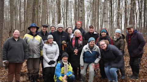 A group photo in a forest of On-the-Land Learning participants 