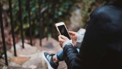 A person looking at a smart phone
