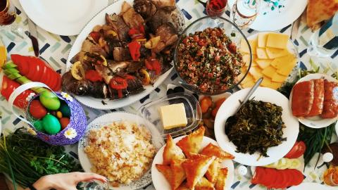 A feast is laid out across a table. Courtesy of Unsplash.