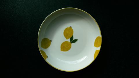 An image of a bowl placed on a dark table. Courtesy of Martin on Unsplash.