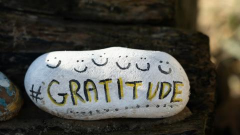 A rock with the word "gratitude" painted on it. Courtesy of Unsplash.