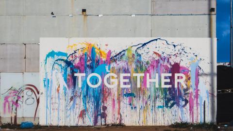 the word "together" painted on a wall