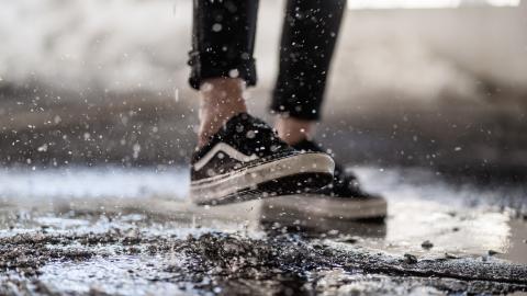 https://www.pexels.com/photo/crop-person-walking-through-puddles-on-asphalt-3908085/