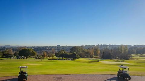 An image of a country club with golf carts. Courtesy of Pexels.