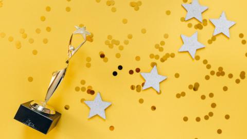 trophy and stars on yellow background