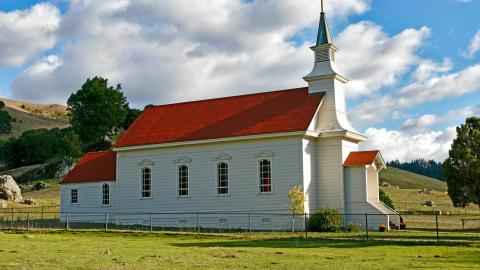 An image of a church in a field. Courtesy of Pixaby.