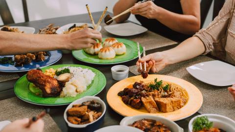 Image of people sharing a meal together. Courtesy of Pexels.